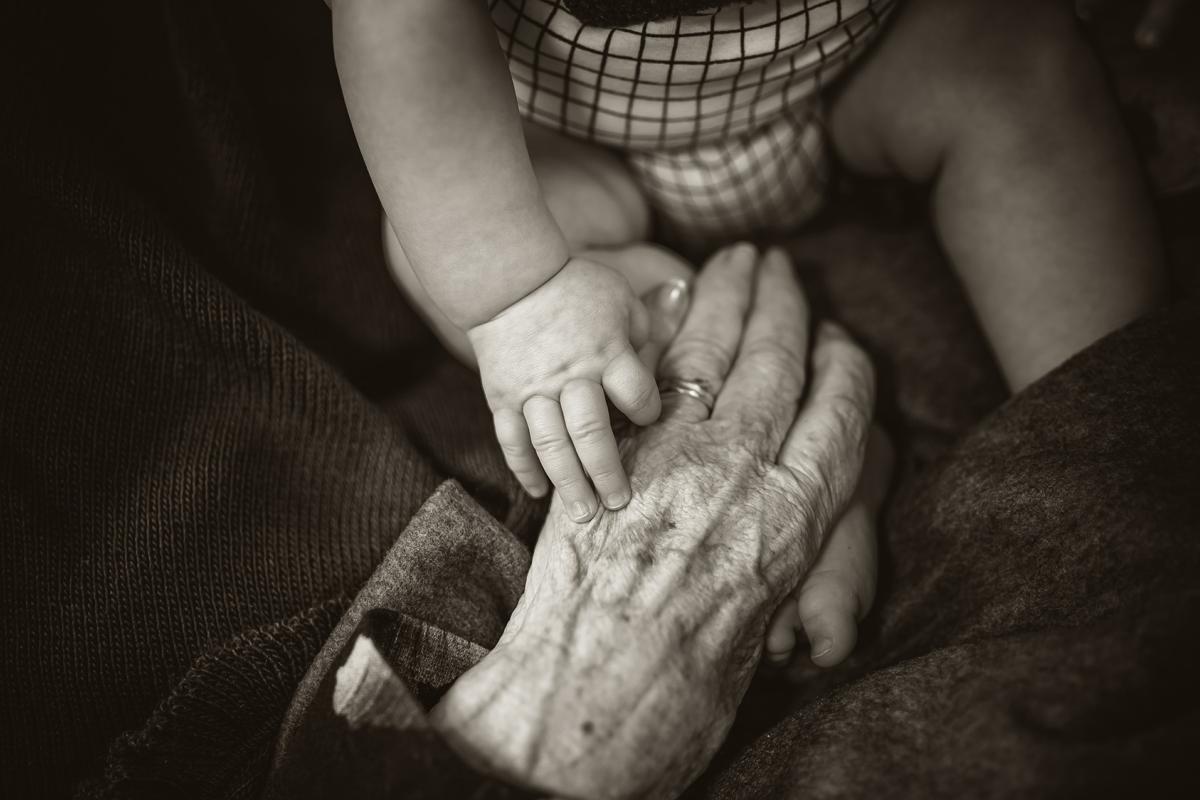 Baby holding a grandparent's hand