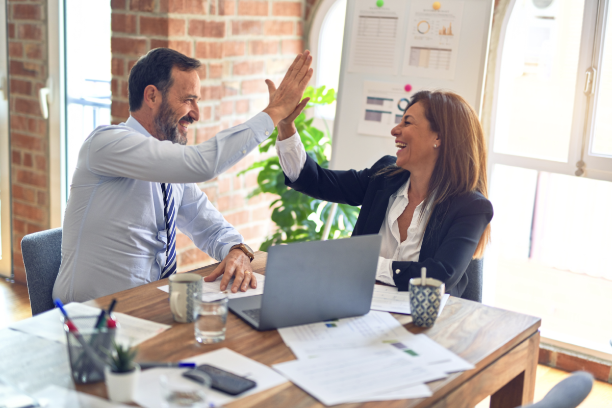Business people "high-fiving"