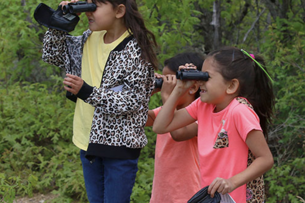 Photo of children looking through binoculars