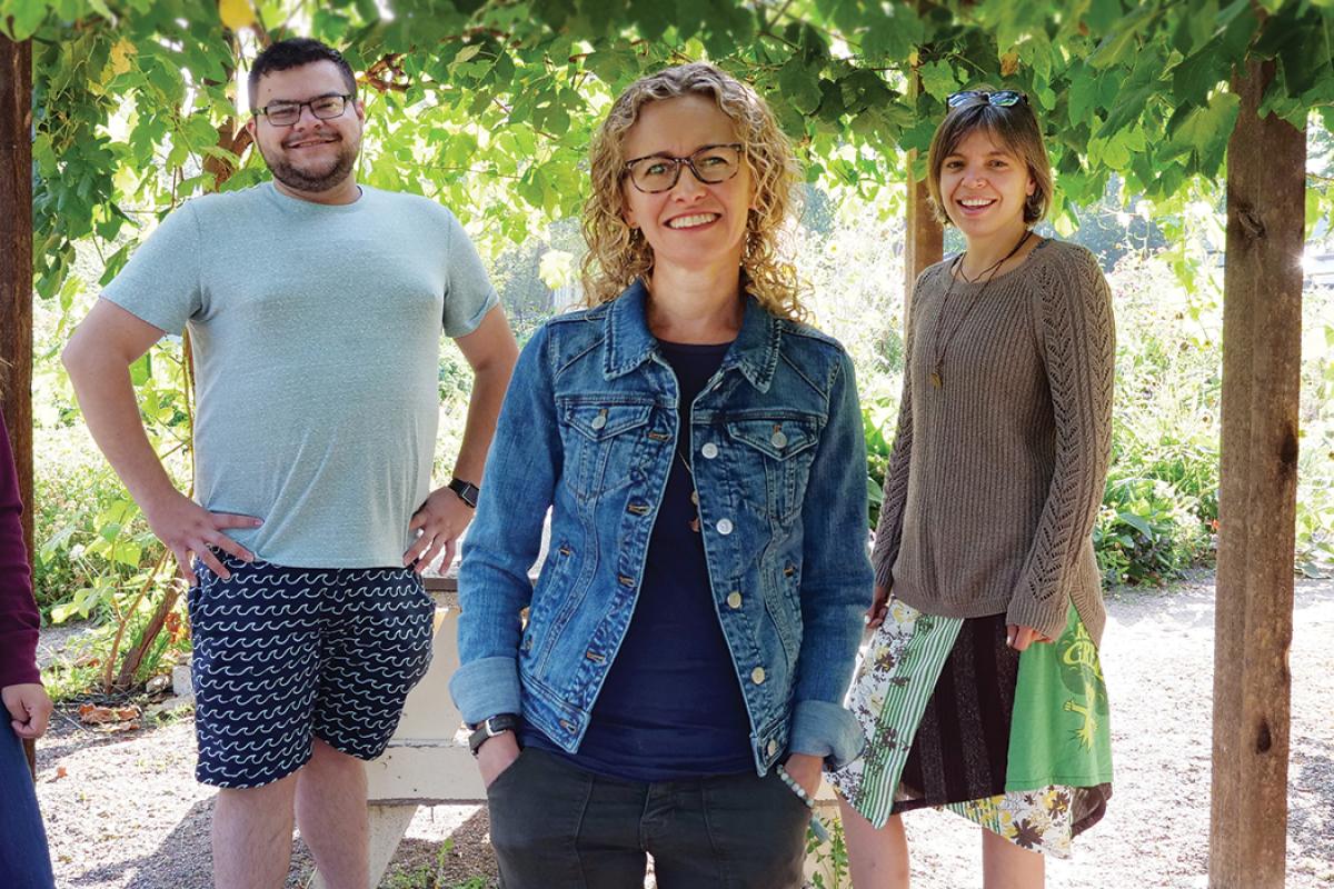 Staff in a garden smiling for a photo