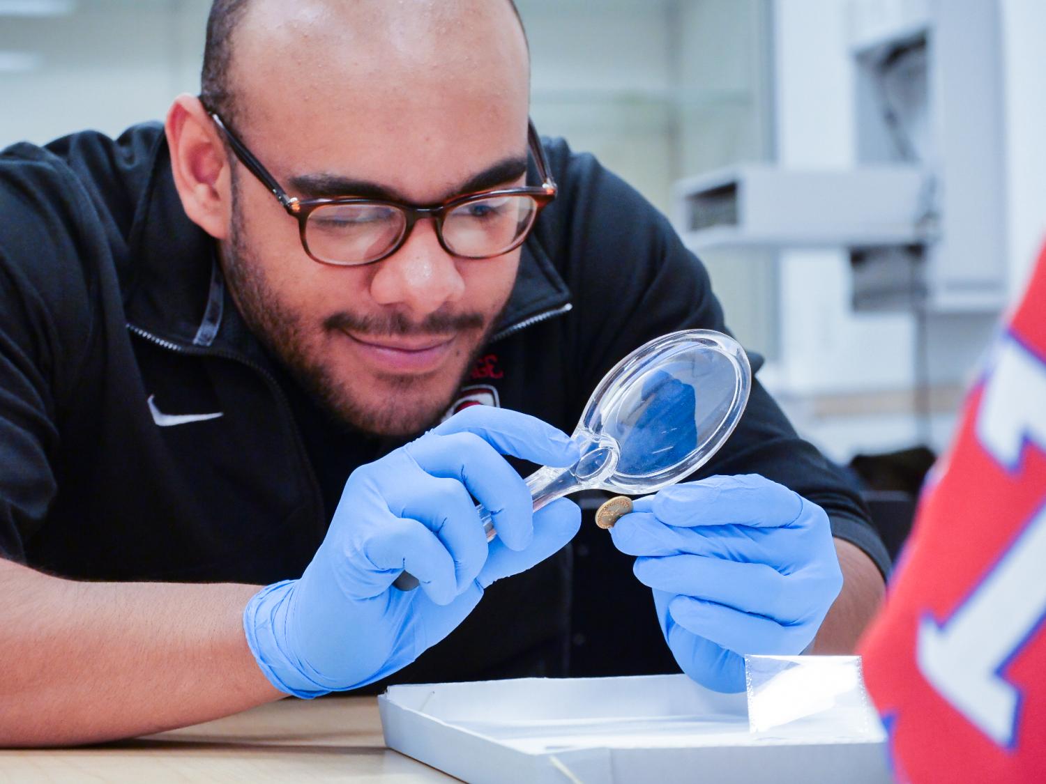 Student looking at a coin