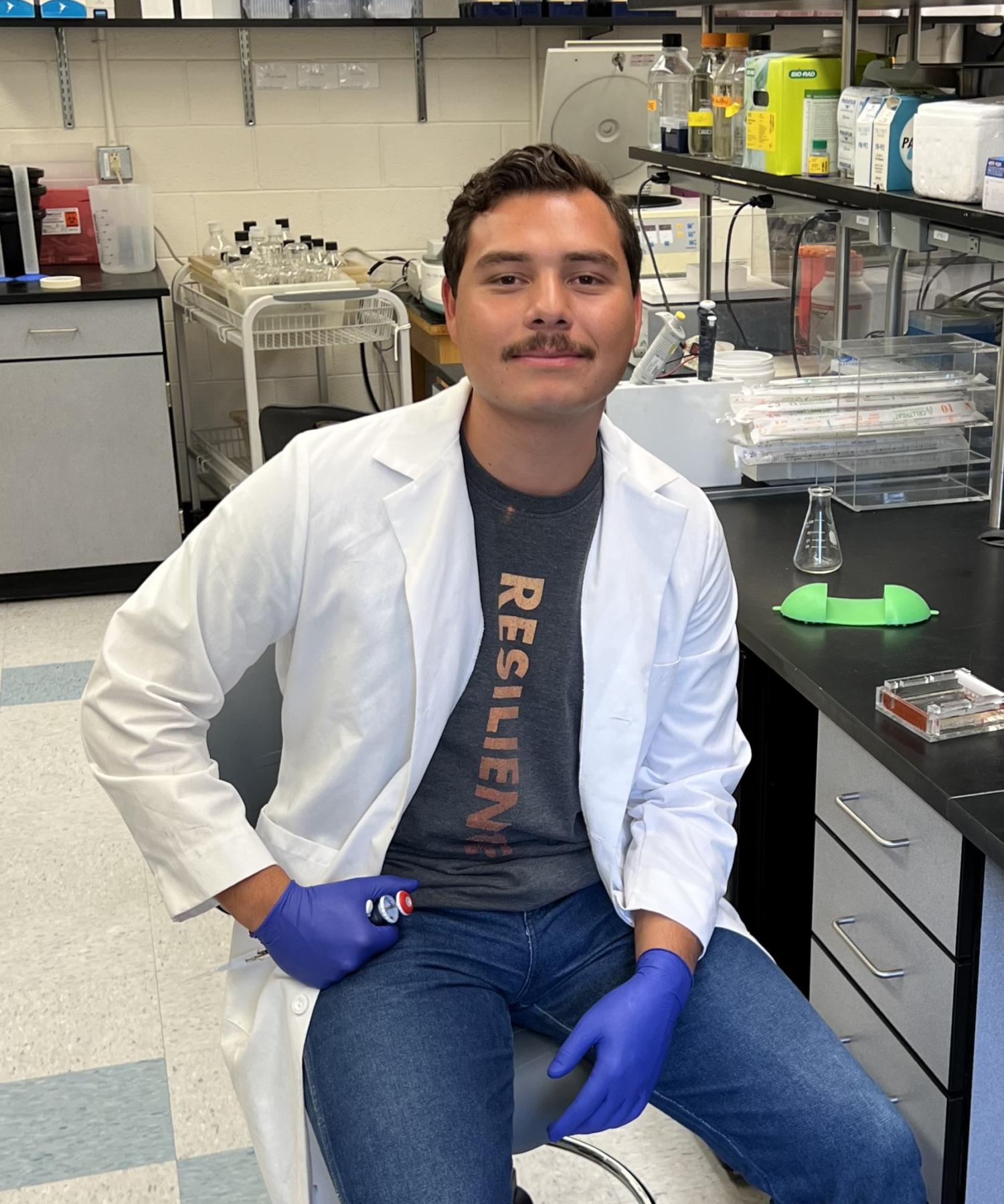 Manny Cruz in a lab coat