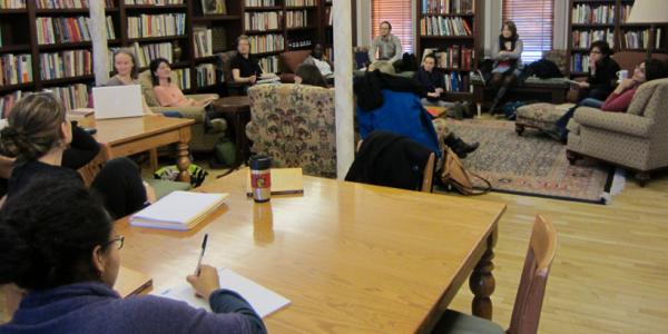 A group of students sitting around a classroom.