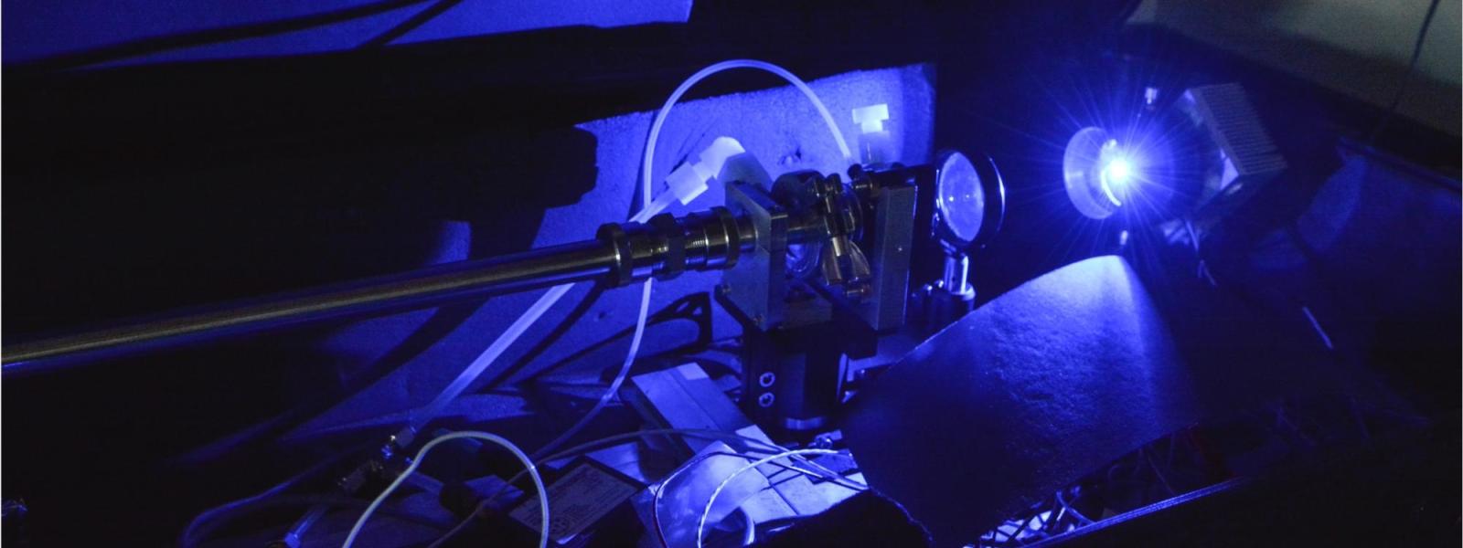 a chemistry lab experiment is darkly lit.