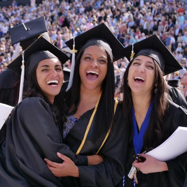three students celebrate graduation