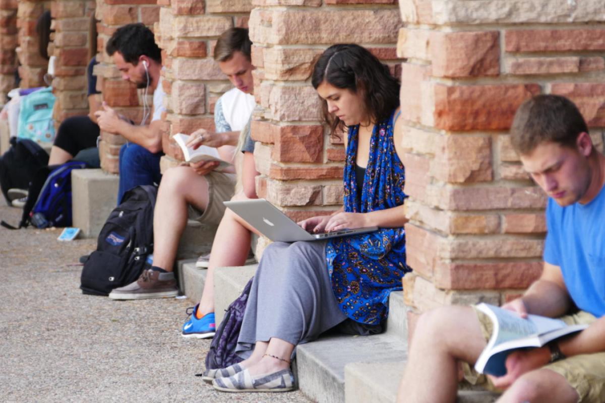 Line of students individually reading or working
