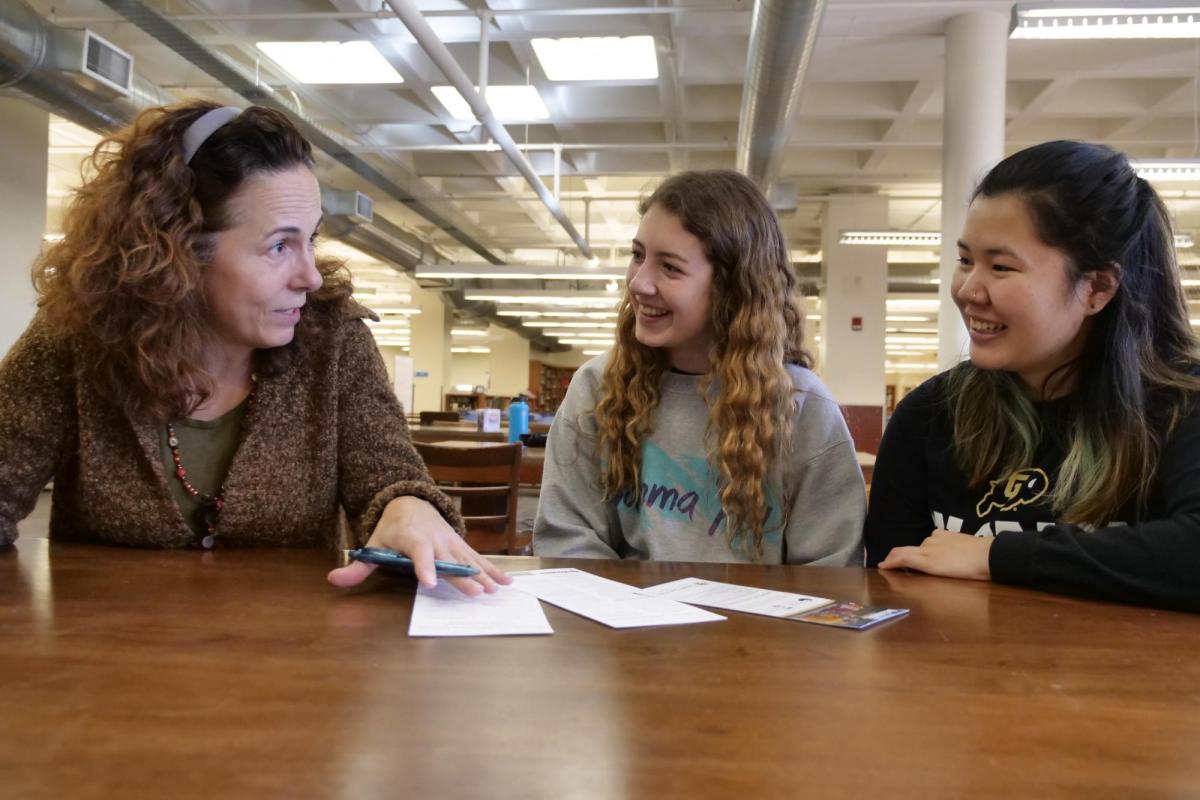 advisor working with two students