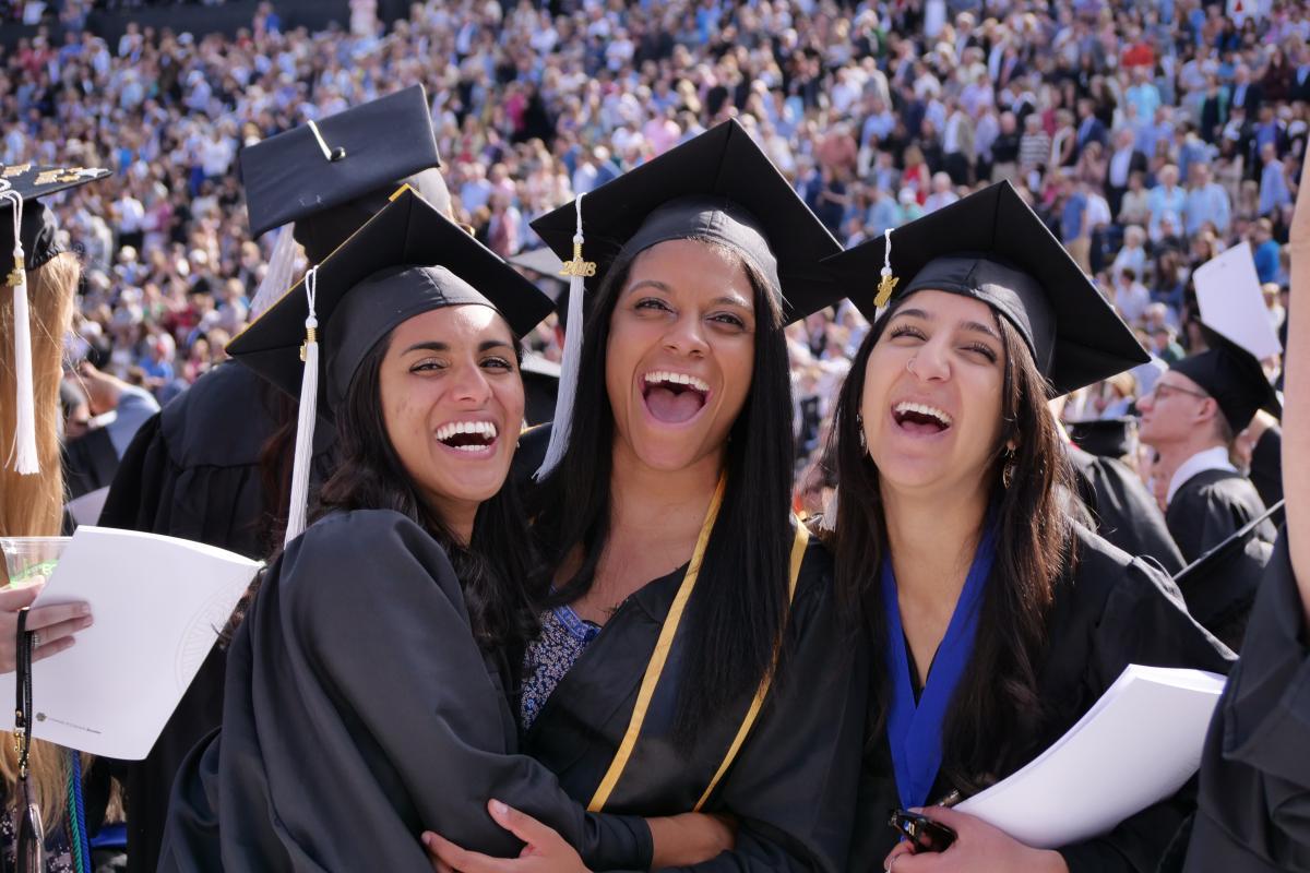students at graduation posing for photo