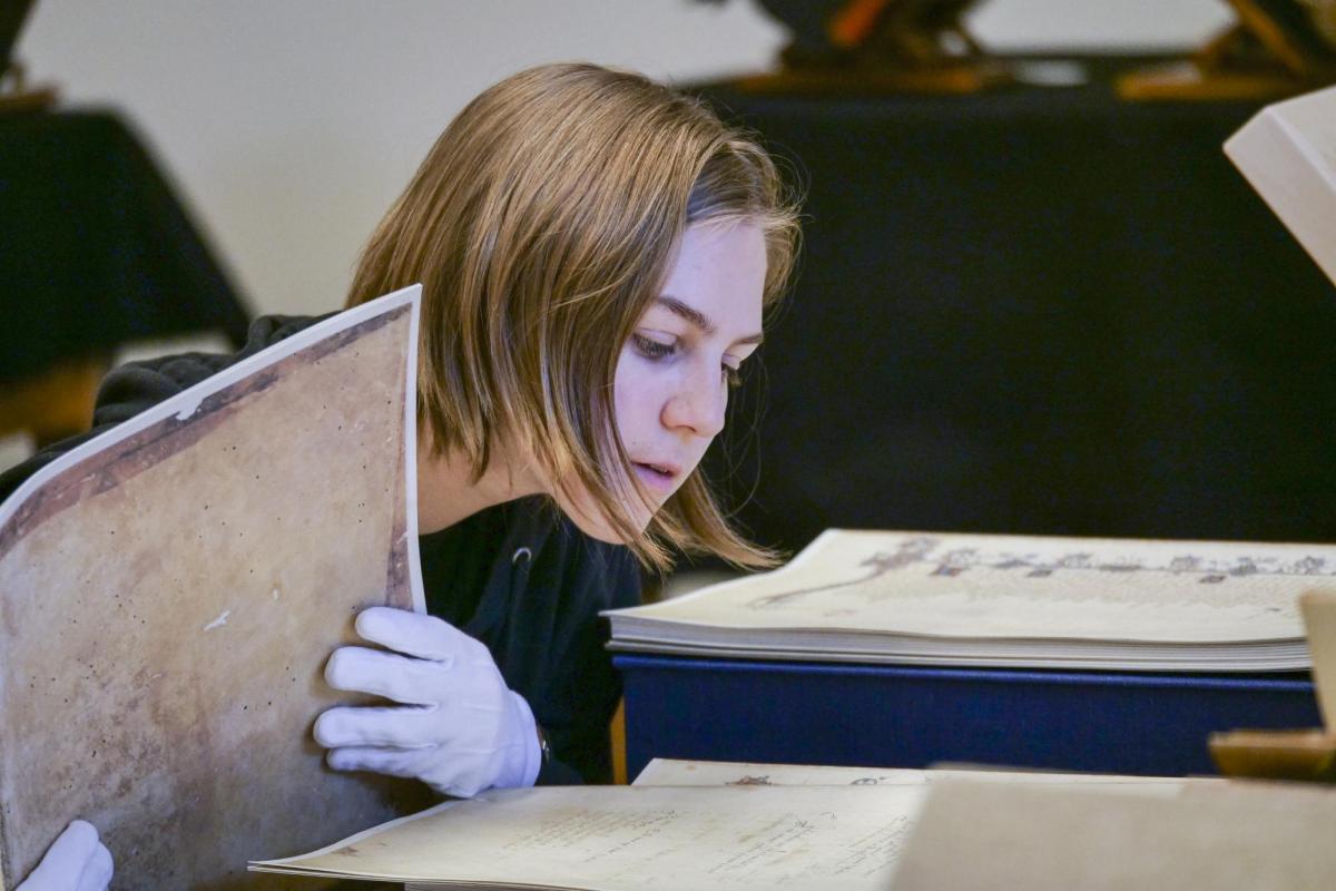 Student studies historical manuscrpit