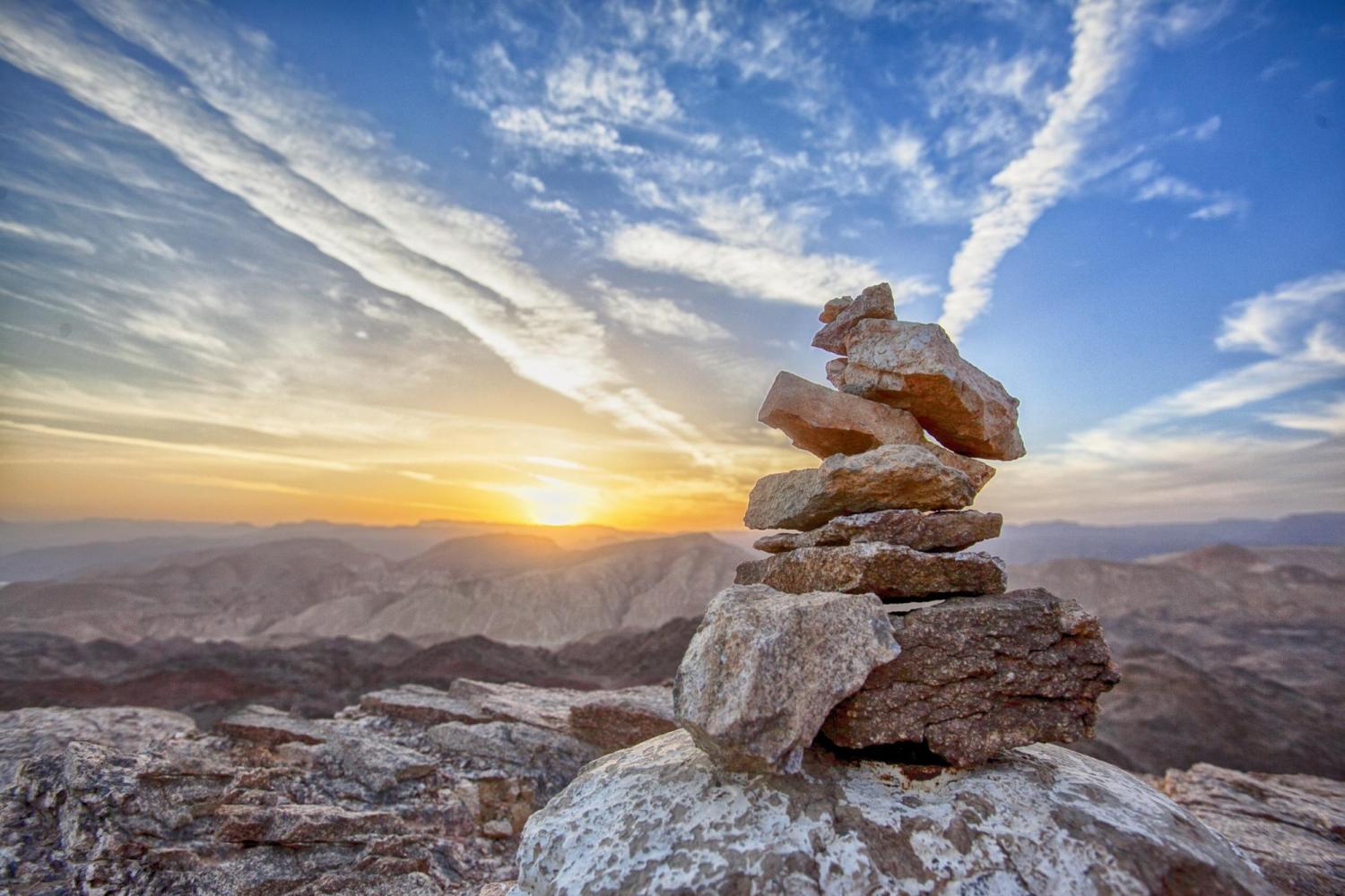balanced rock cairn at sunset