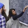 instructor at blackboard explaining algorithm