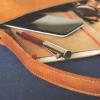 leather journal sits on a desk. Image by Lum3n from Pixabay.