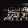 A series of book shelves packed full of hardback books.