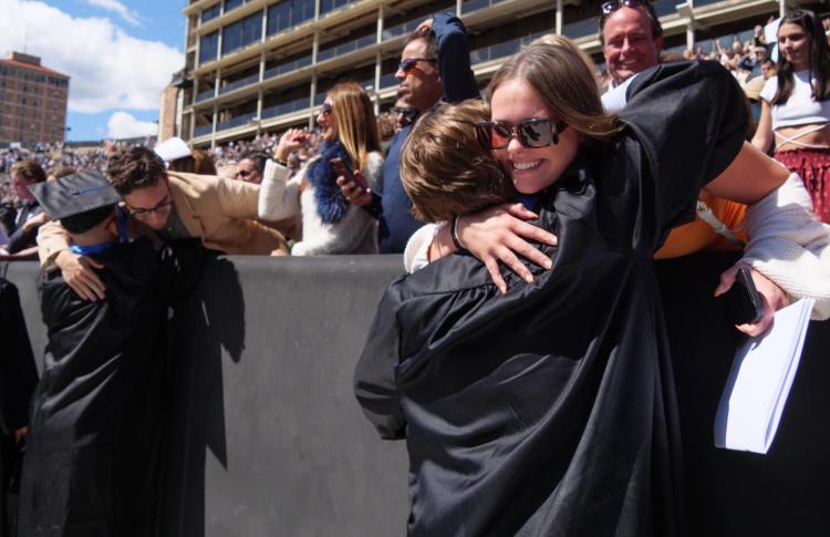 Woman hugging graduating student