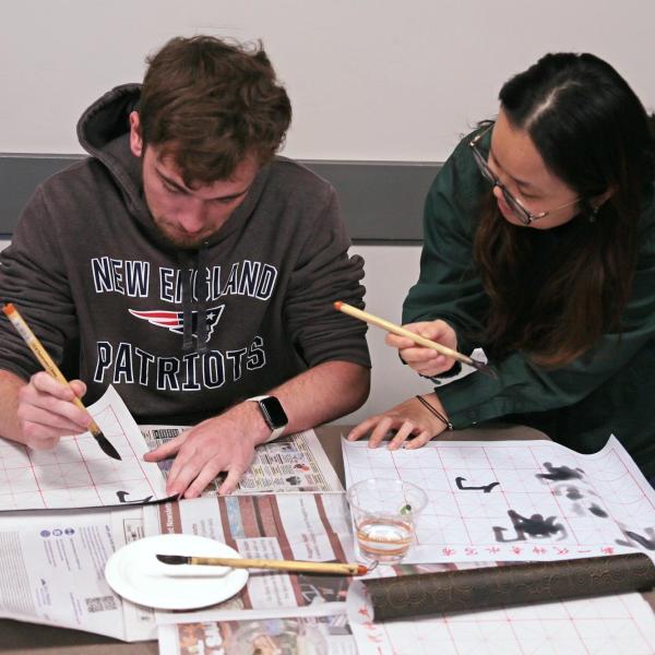 Yingjie Li helping Nathan Boesen