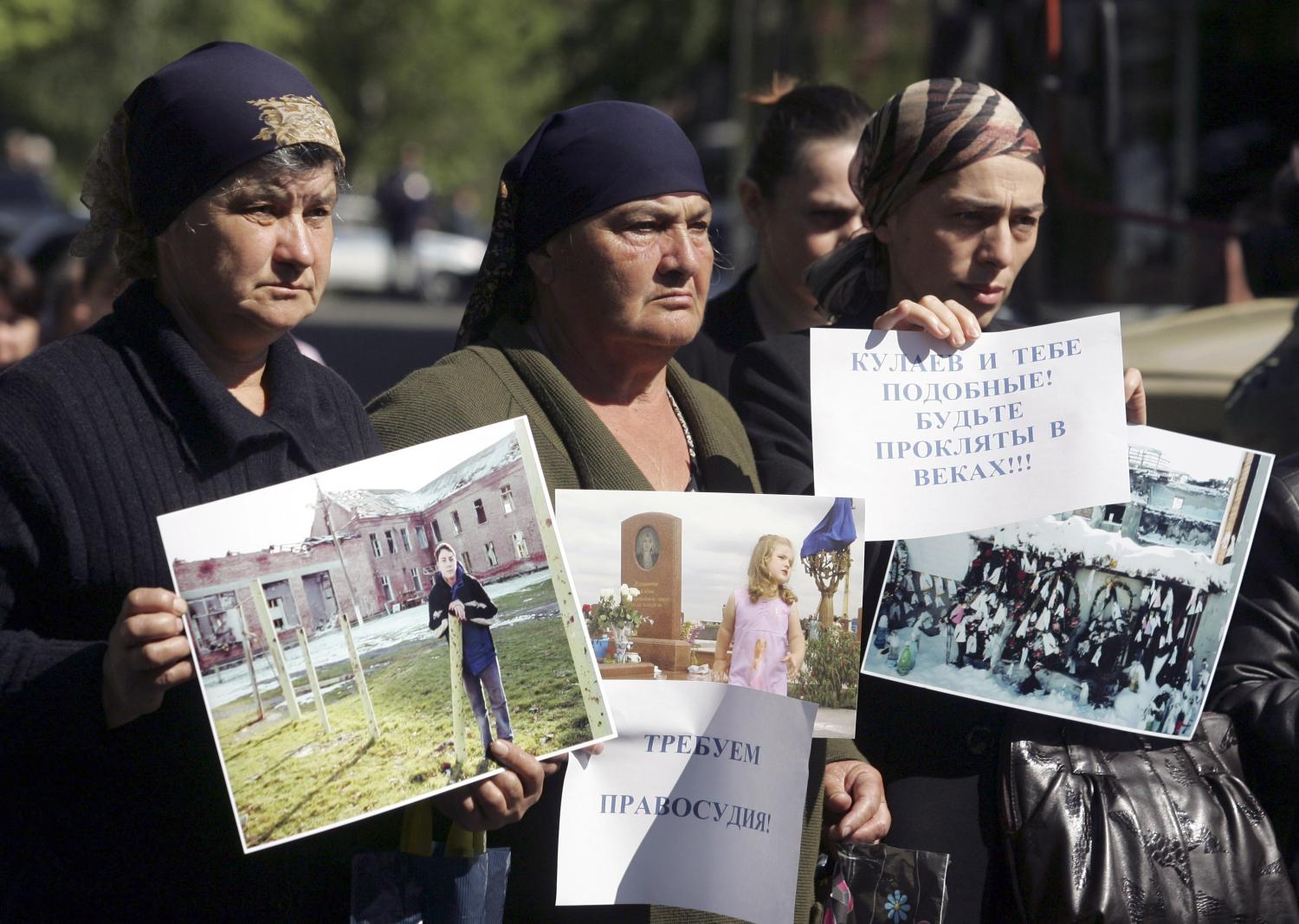  “We demand justice!” (left) and “Kulayev and the like, be damned for all eternity!!!” (AP Photo/Sergei Grits)