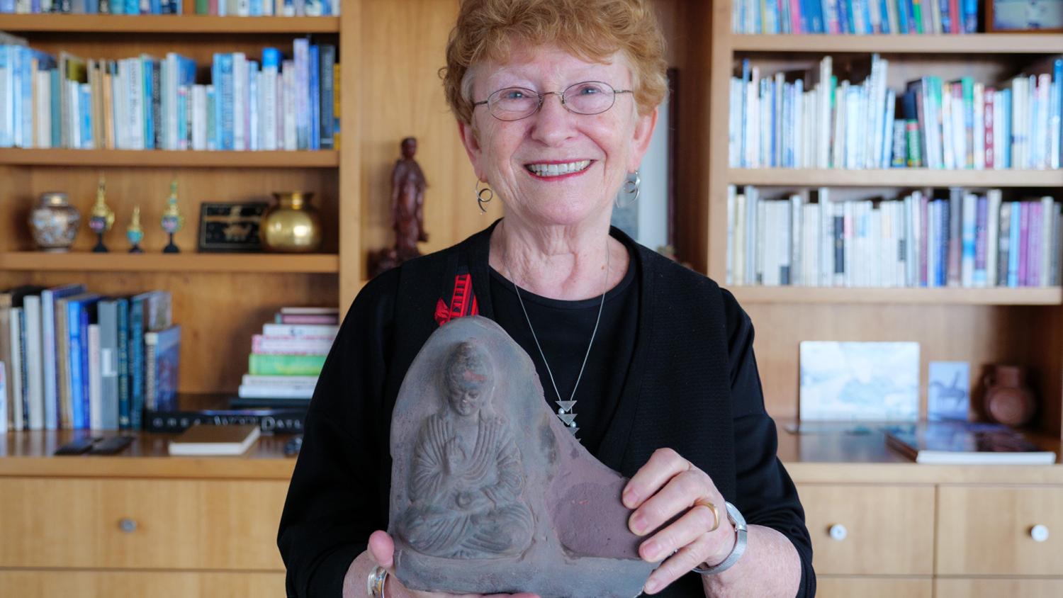 Jane Menken holds a statue