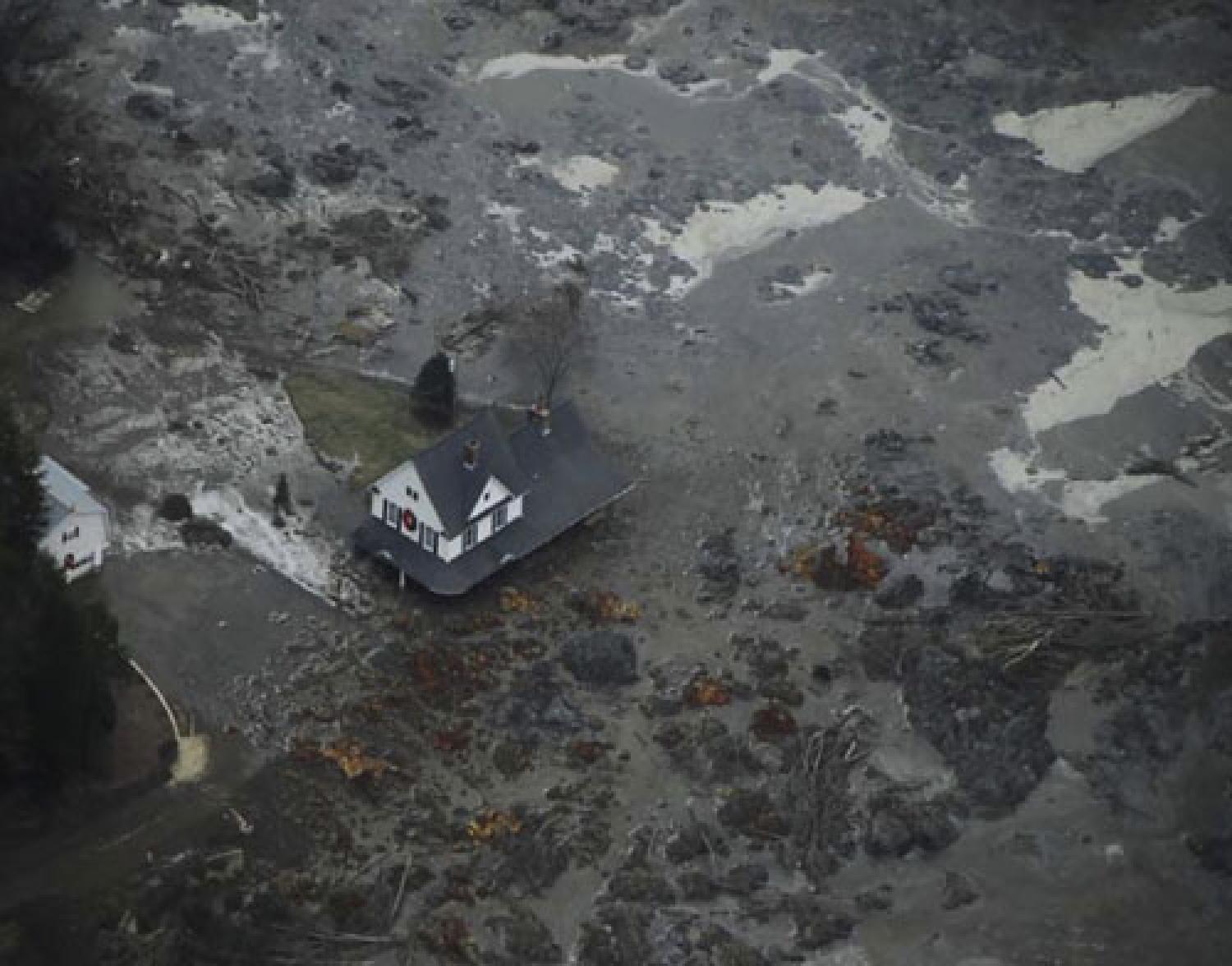 A house is shown surrounded by coal fly ash after a retention pond near Kingston Fossil Plant in Tennessee overflowed.