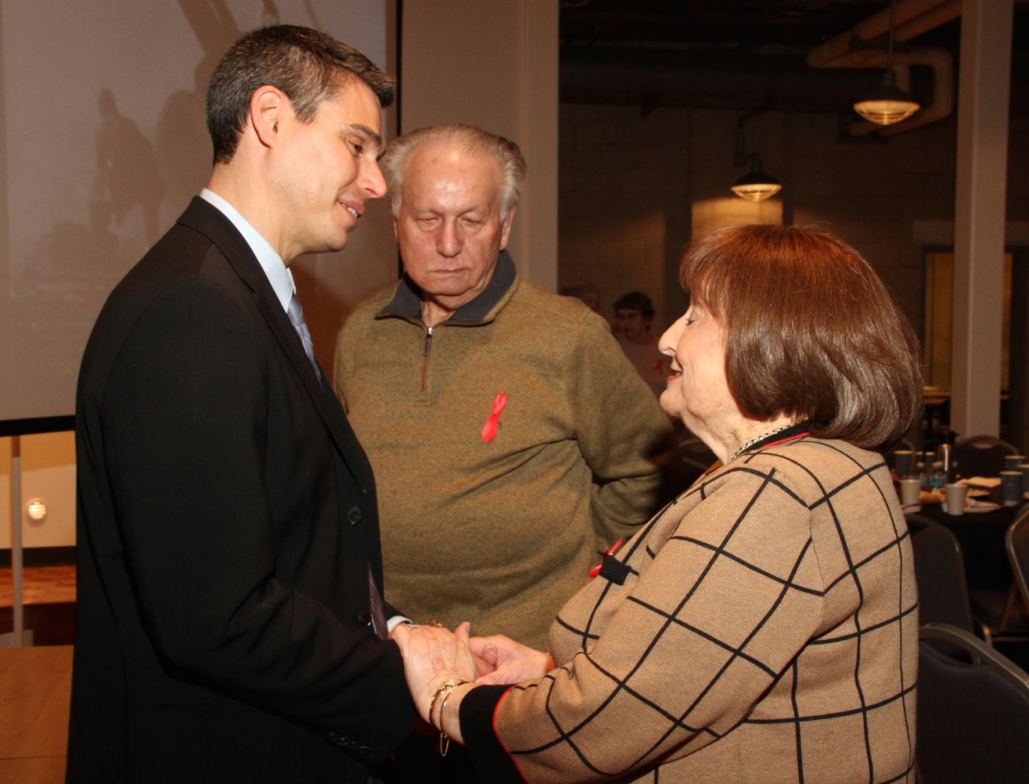 Professor David Shneer, left, shares a word with people who attended a gathering of Soviet veterans and Soviet Holocaust survivors last month. Photo courtesy of the Illinois Holocaust Museum and Educational Center.