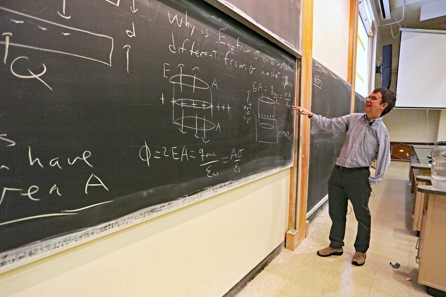Eric Cornell writing on blackboard