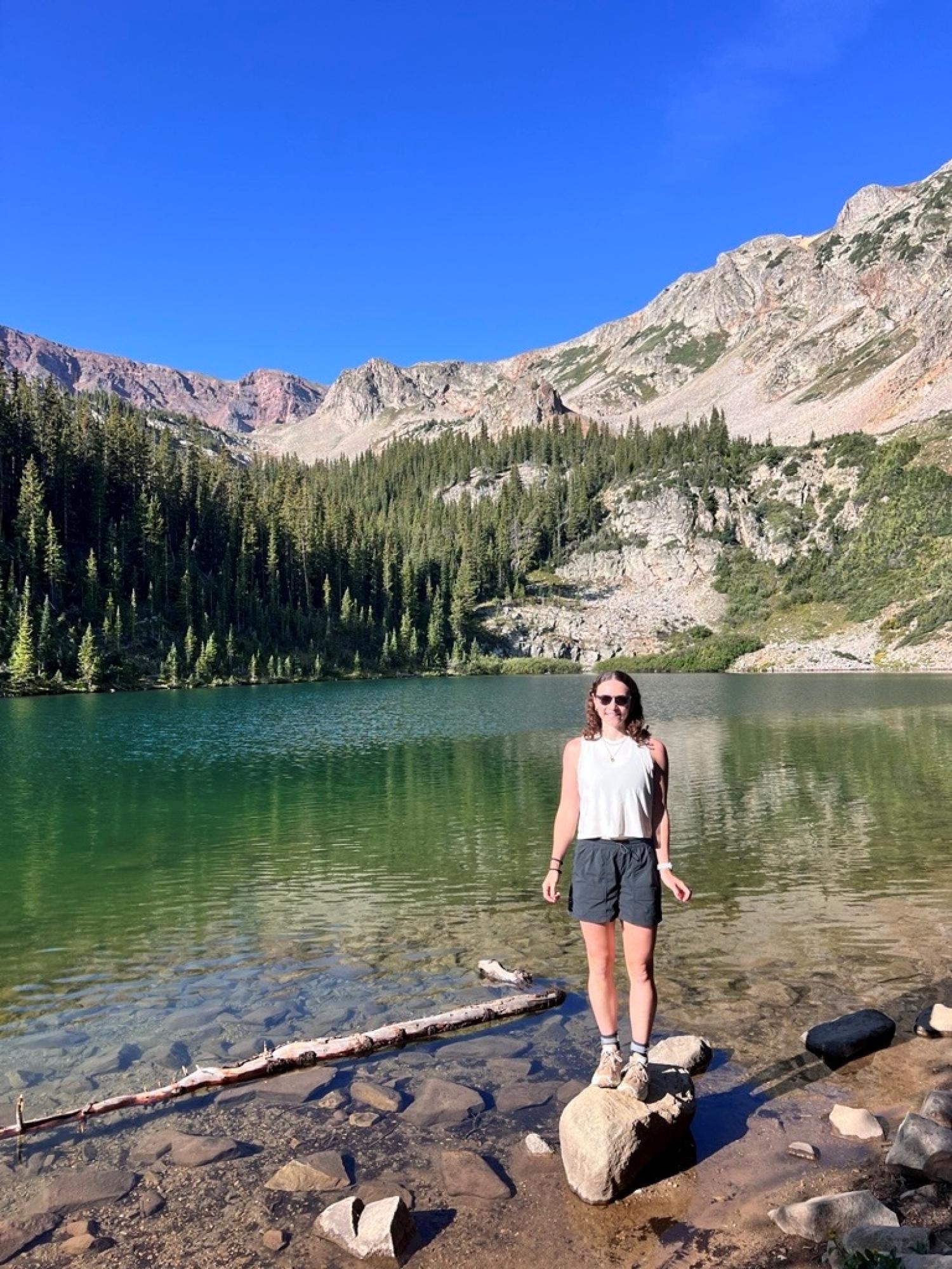 Jane Forman by lake in mountains