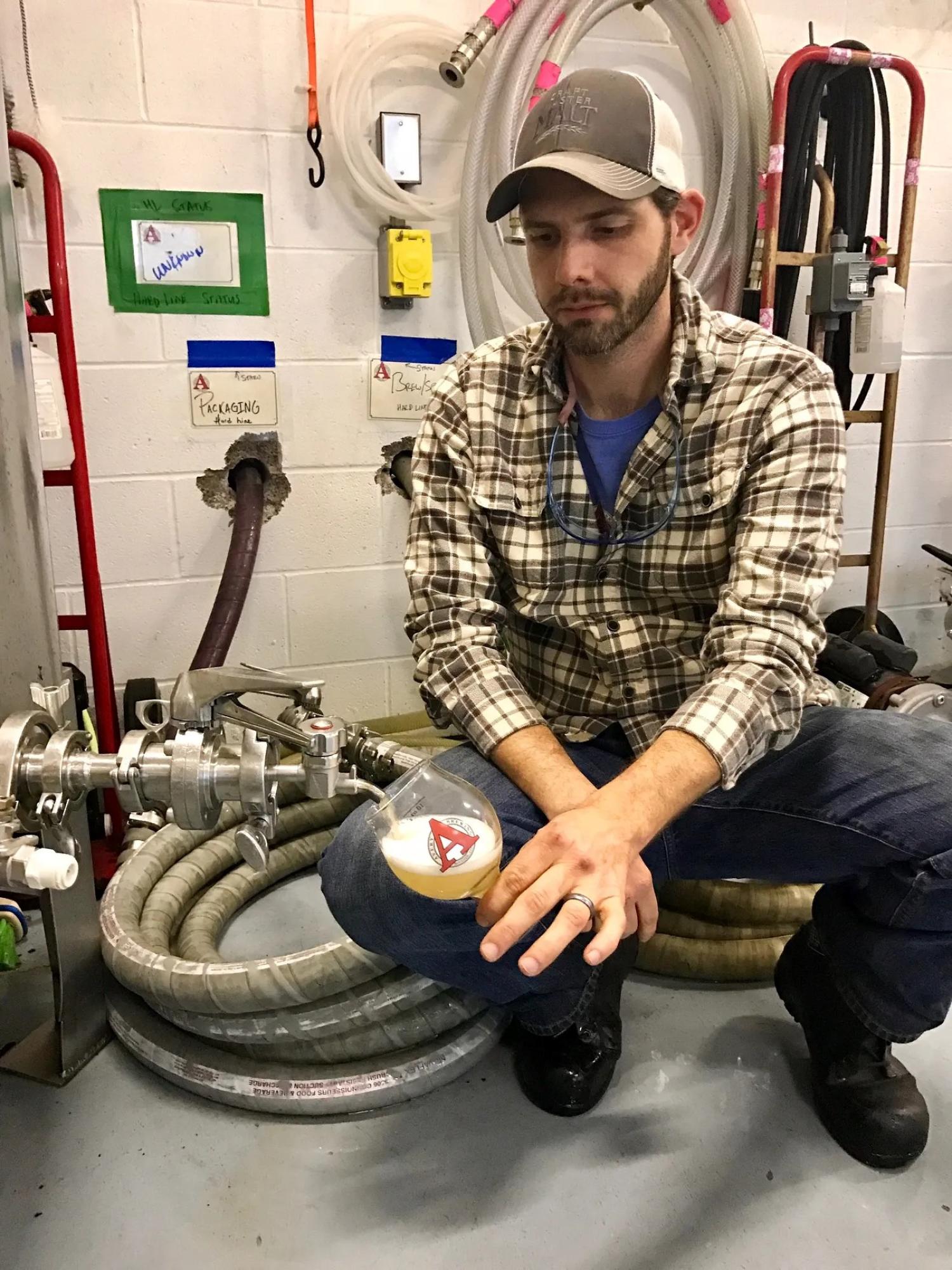 Travis Rupp drawing beer from a tap