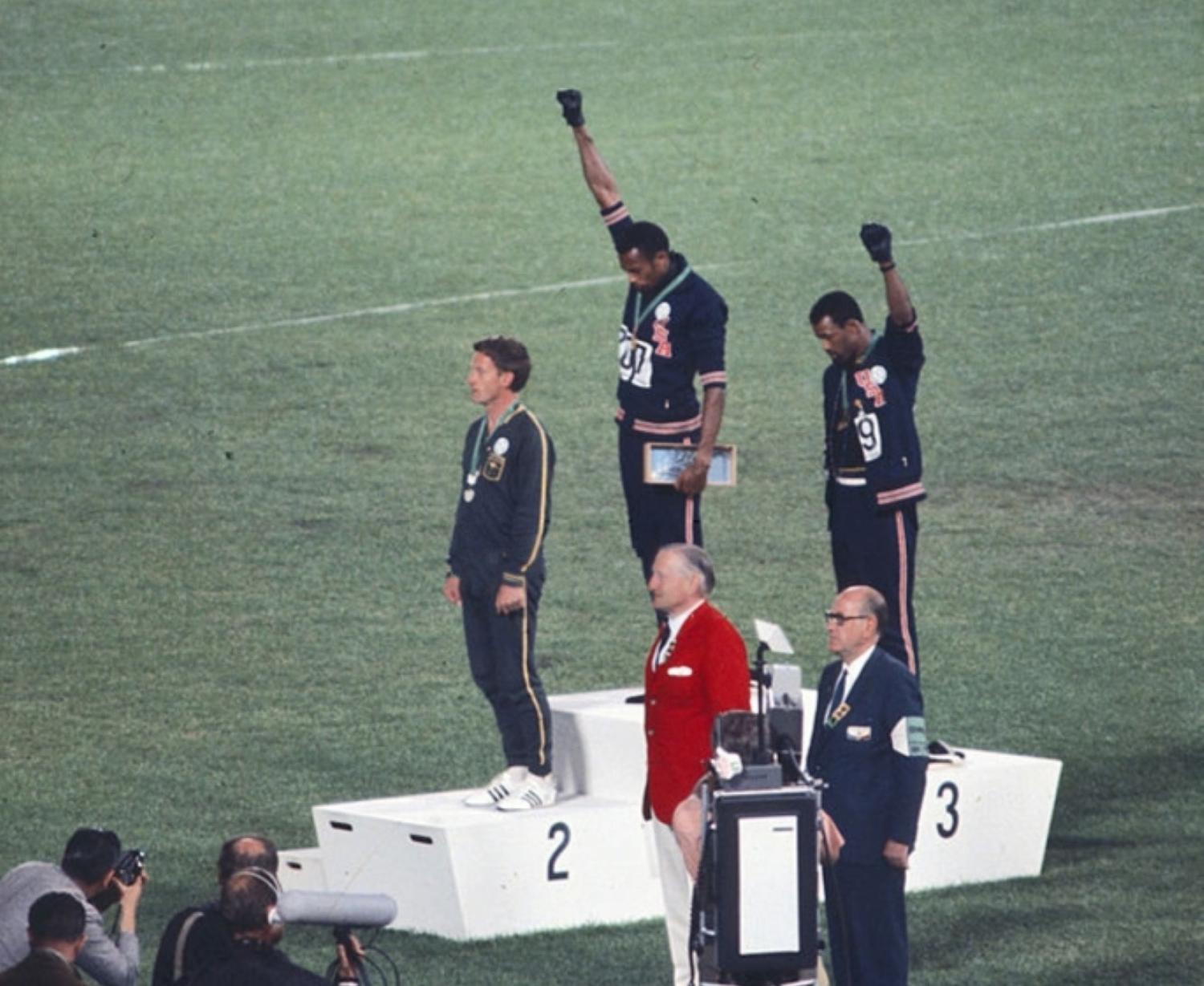 Olympic sprinters raising fists in protest at 1968 Summer Olympics medal ceremony