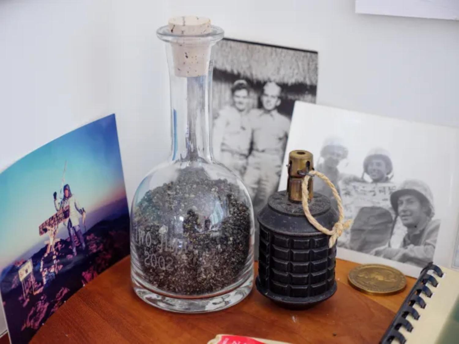 Iwo Jima mementos including bottle of sand, photos and Japanese grenade