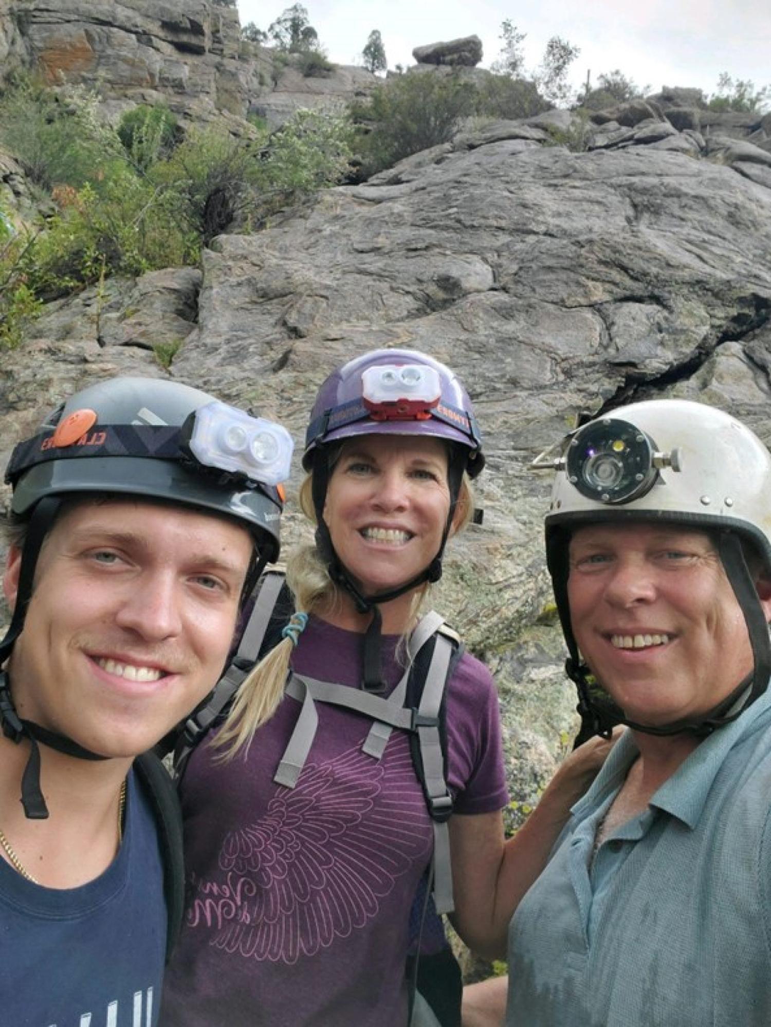 Nathan, Debbie and David Steinmann wearing caving helmets