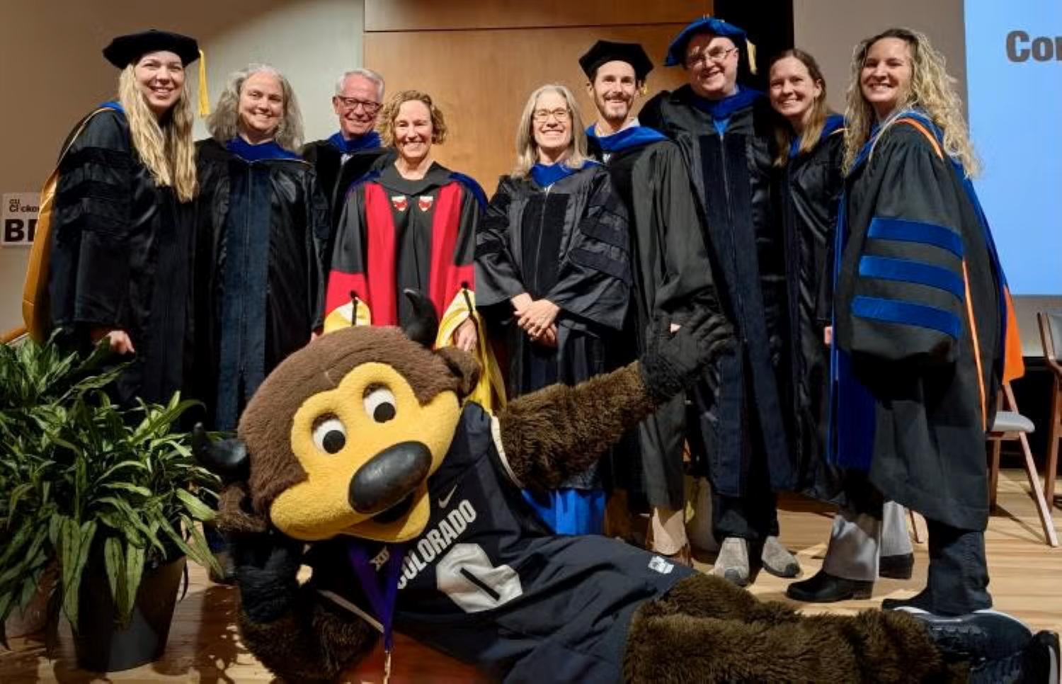 CU Boulder Arts & Sciences Honors faculty wearing caps and gowns at graduation