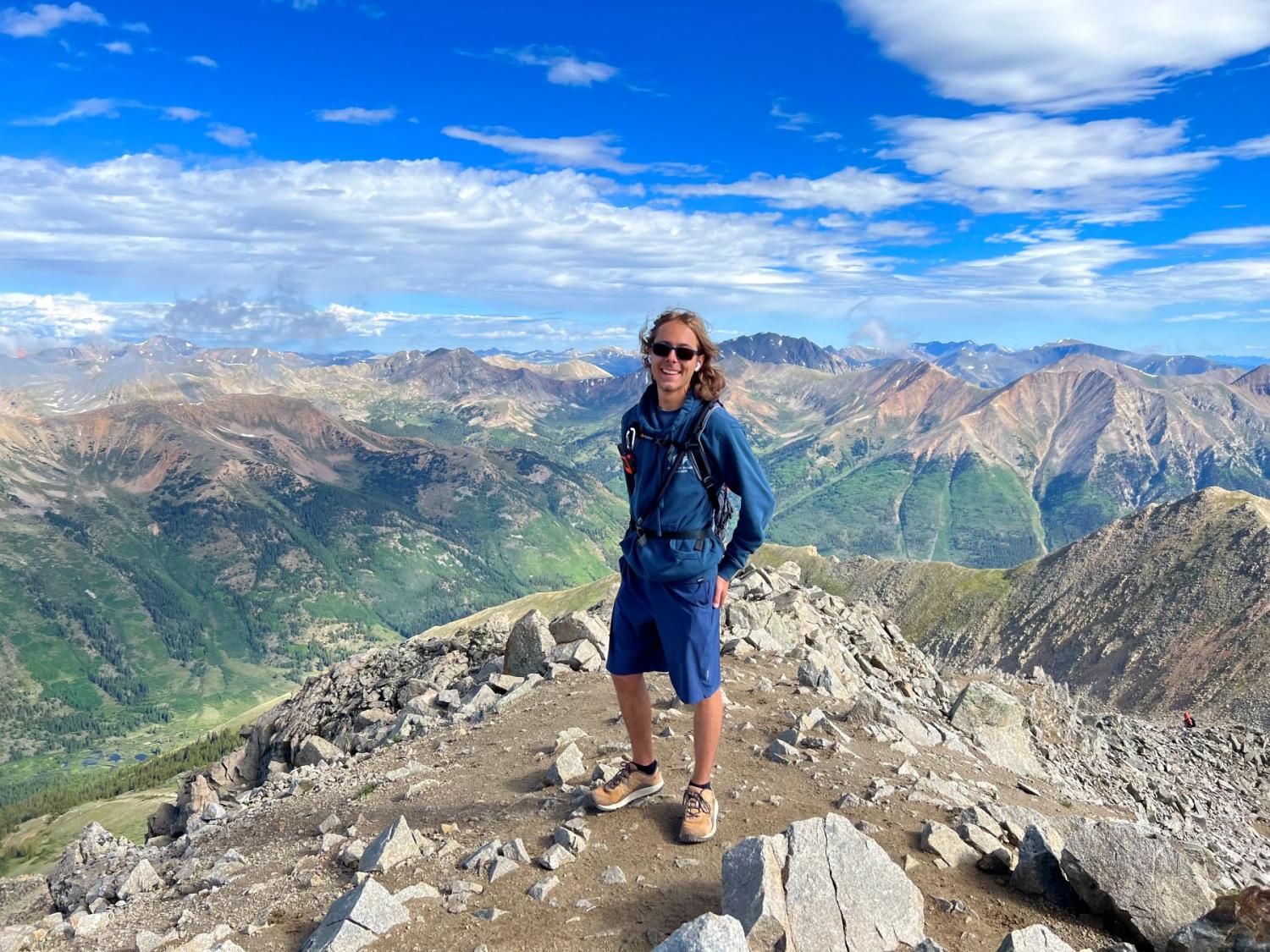 Lucas Gauthier in Colorado mountaintop under blue sky