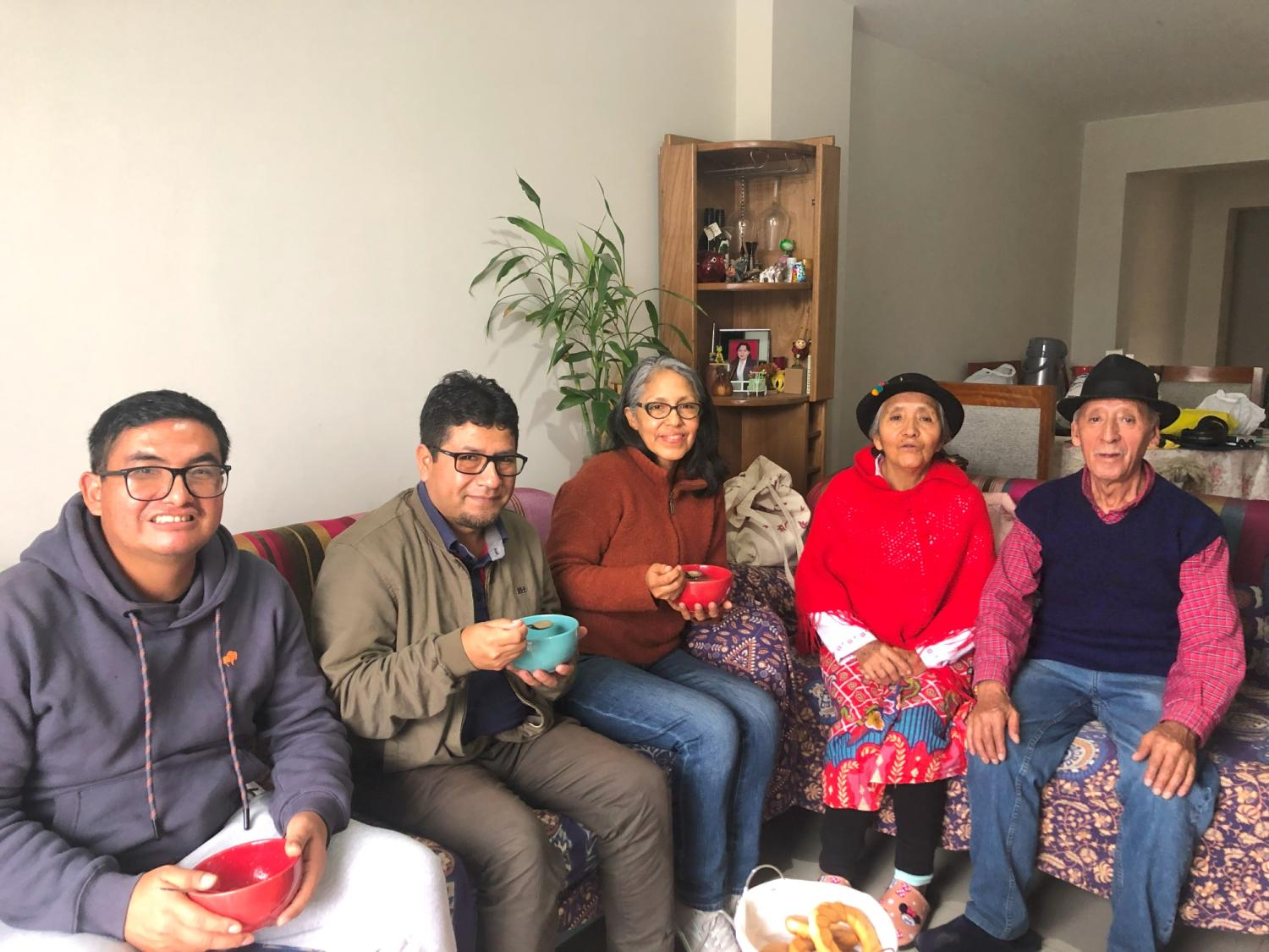 Doris Loayza sitting on couch with four Quechua speakers