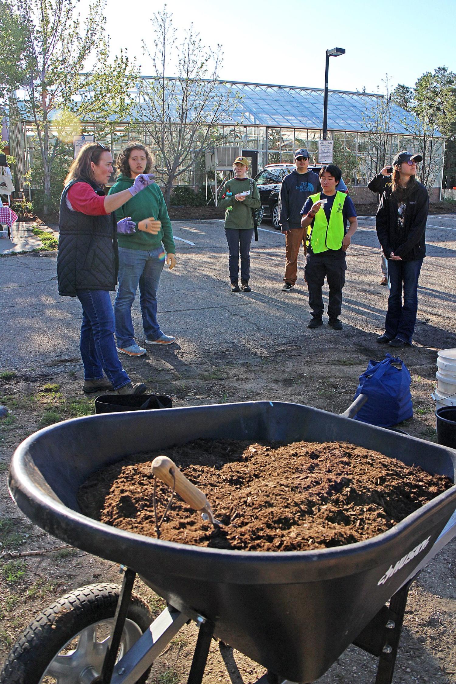 Group of people receiving instructions on planting apple orchard