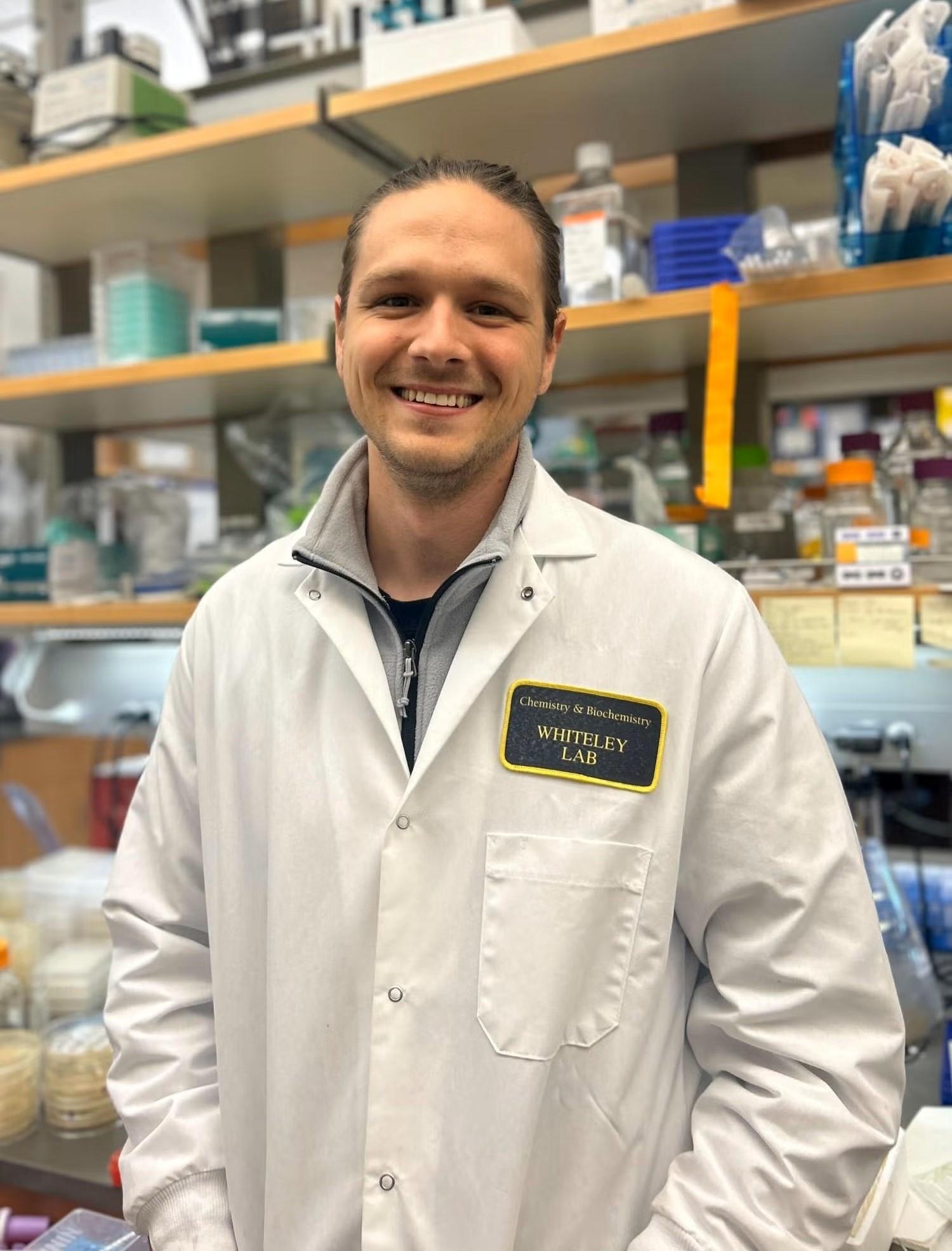 portrait of Nathan Bullen in lab wearing white lab coat