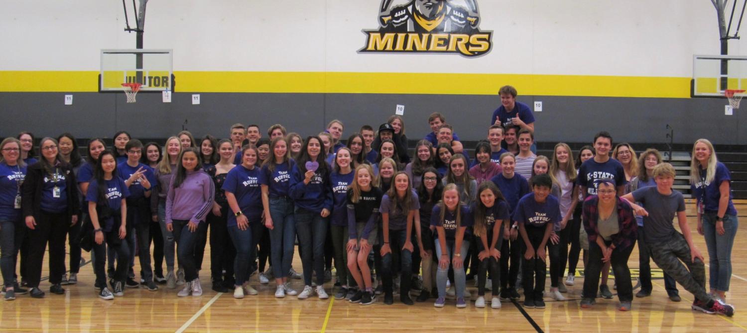 High school students in group photo wearing purple shirts