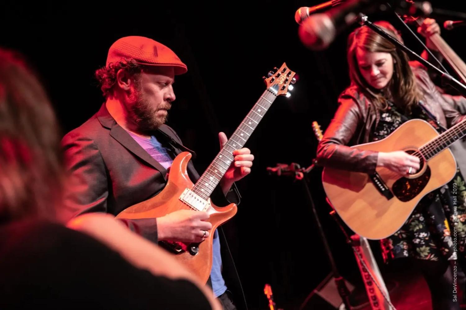 Bill Huston and Monica LaBonte play guitar onstage
