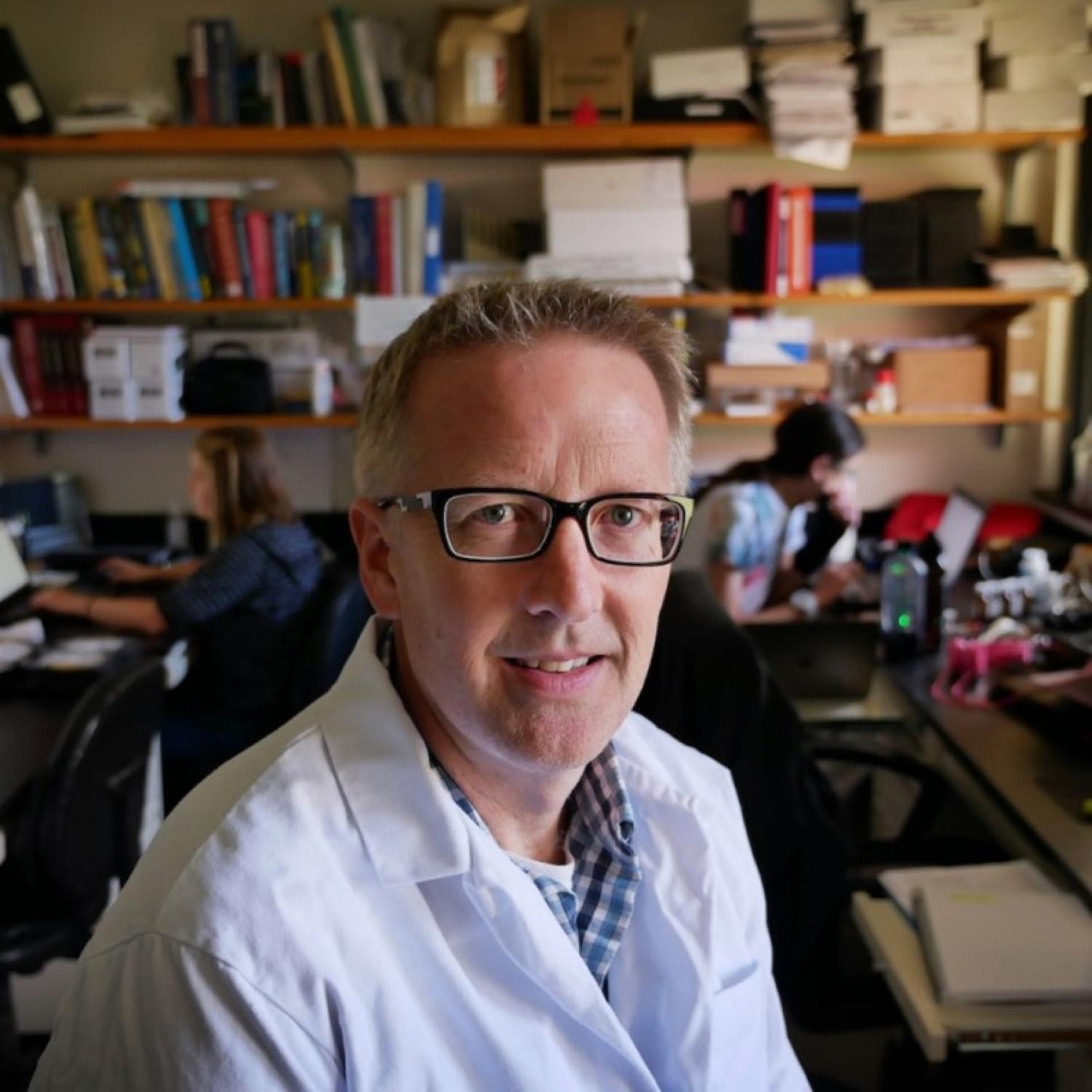 portrait of Christopher Lowry wearing white lab coat