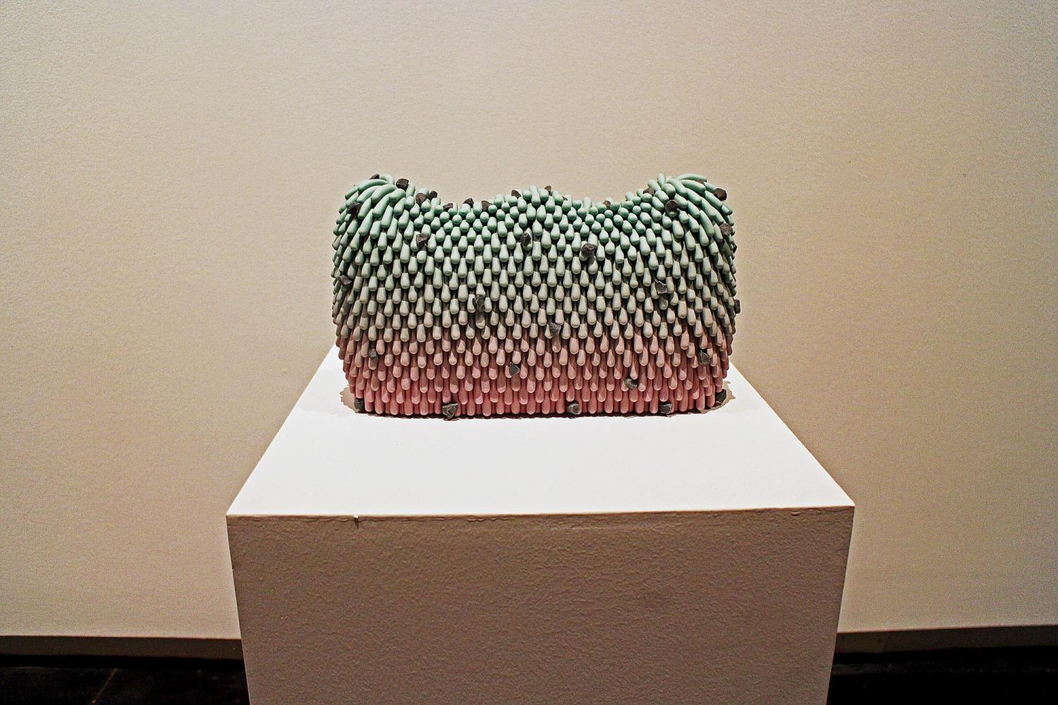 green and pink purse-shaped art piece