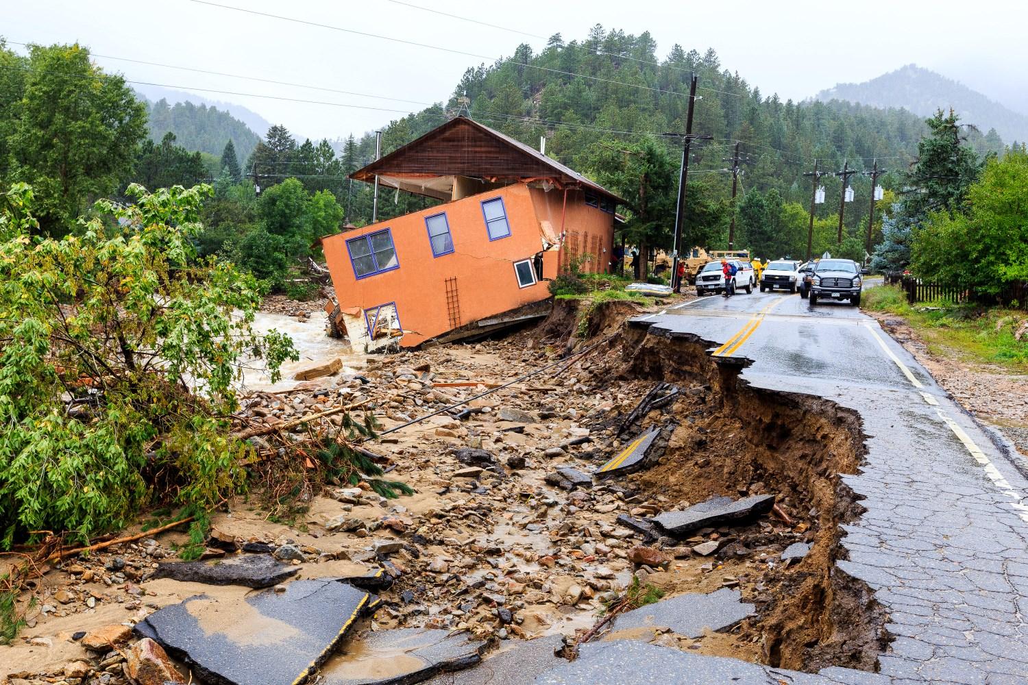 orange house on side of road damaged by 2013 flood in Jamestown, Colorado