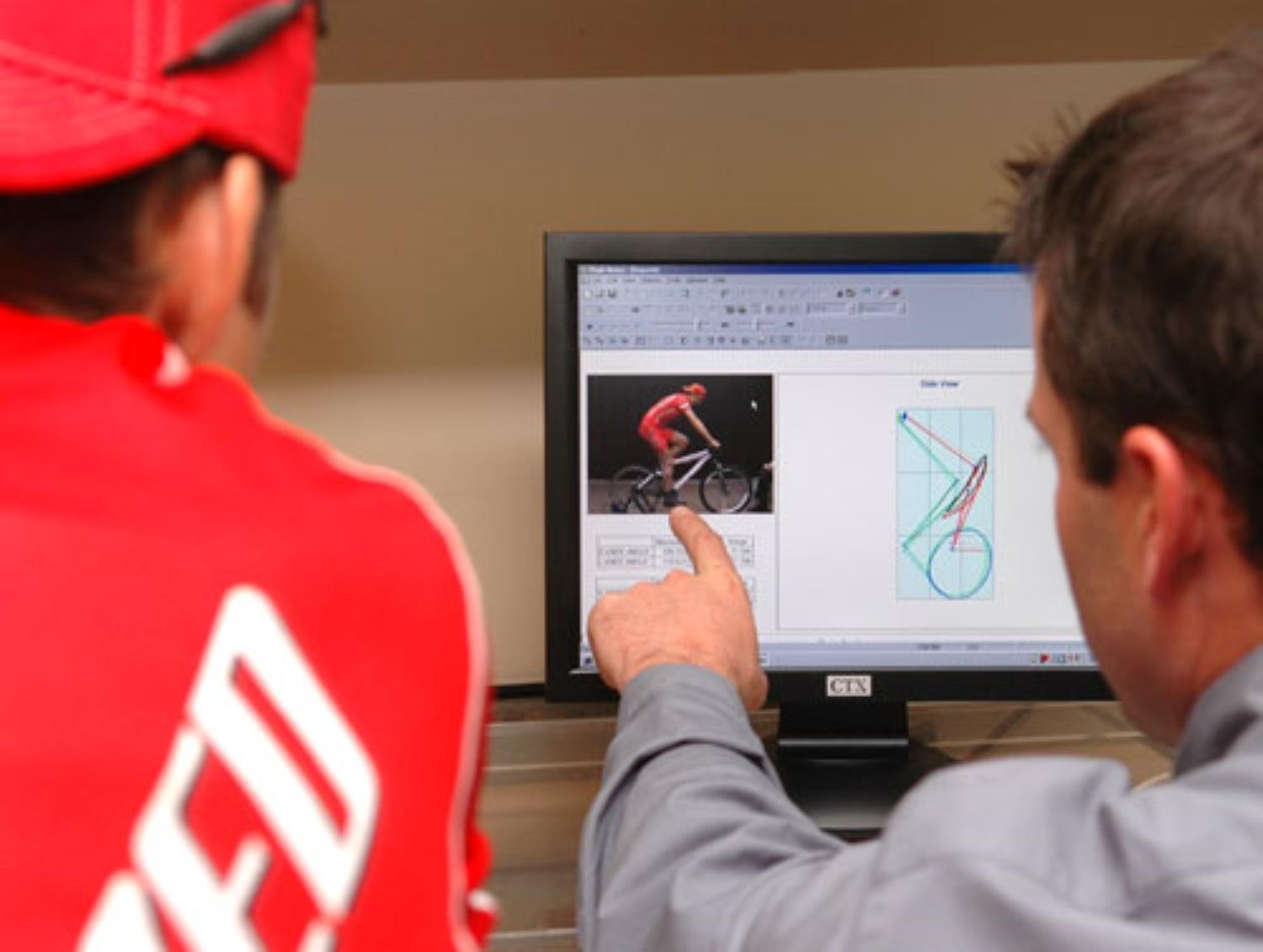Todd Carver pointing at cyclist photo on computer screen