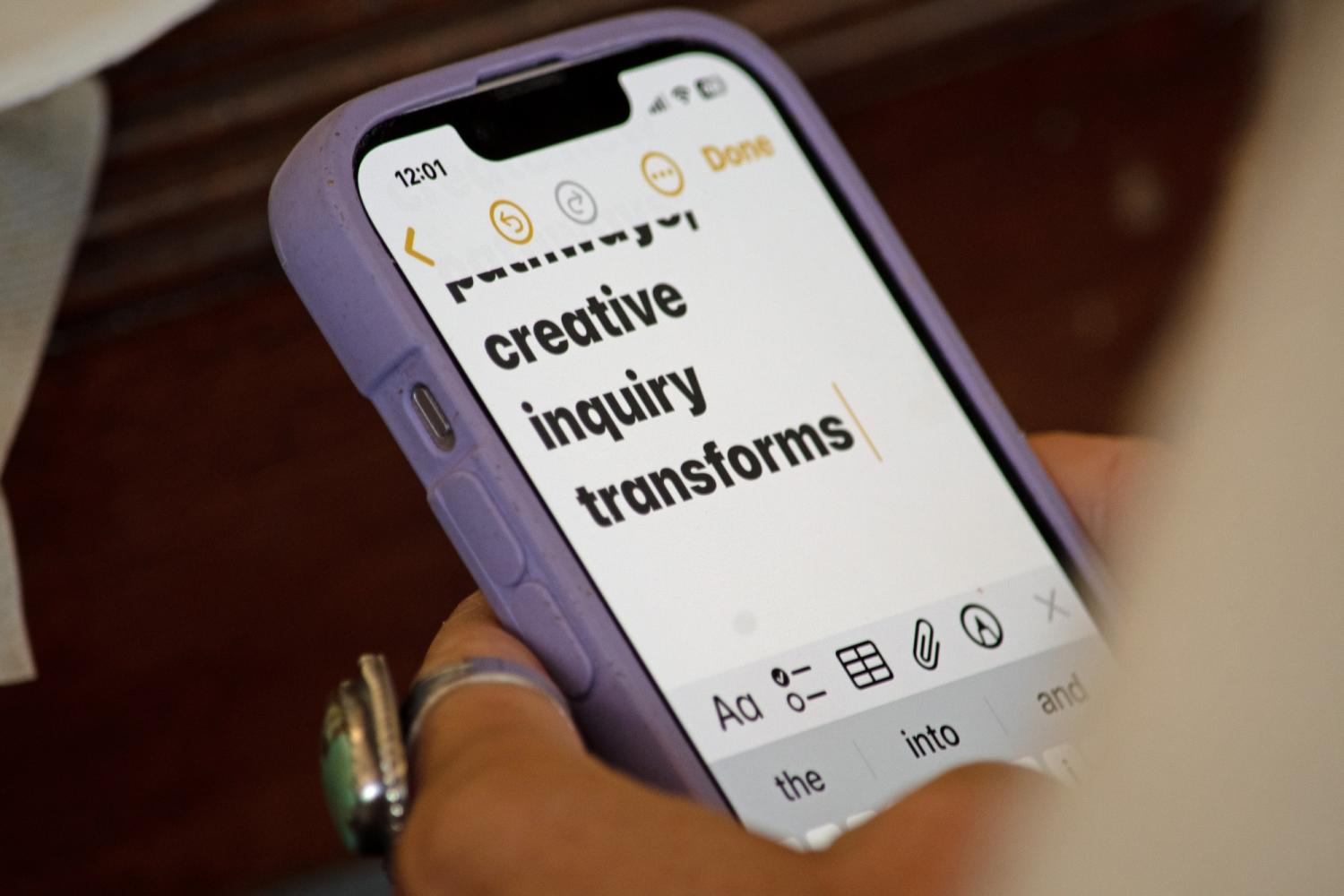 words "creative inquiry transforms" on iPhone screen