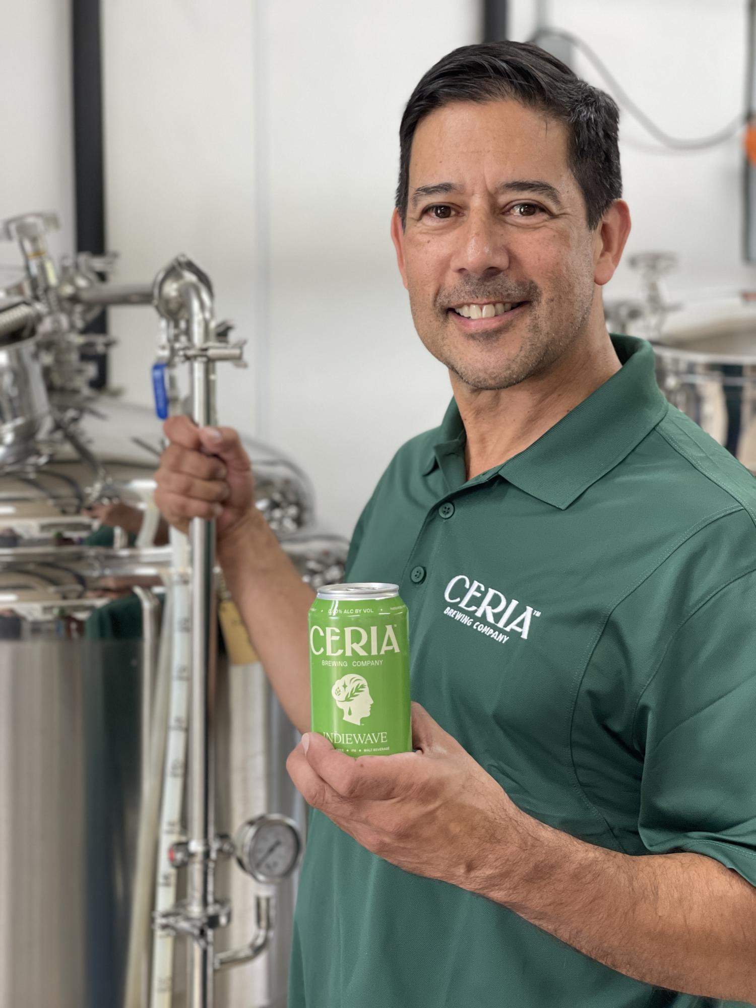 Keith Villa holding can of Ceria beer