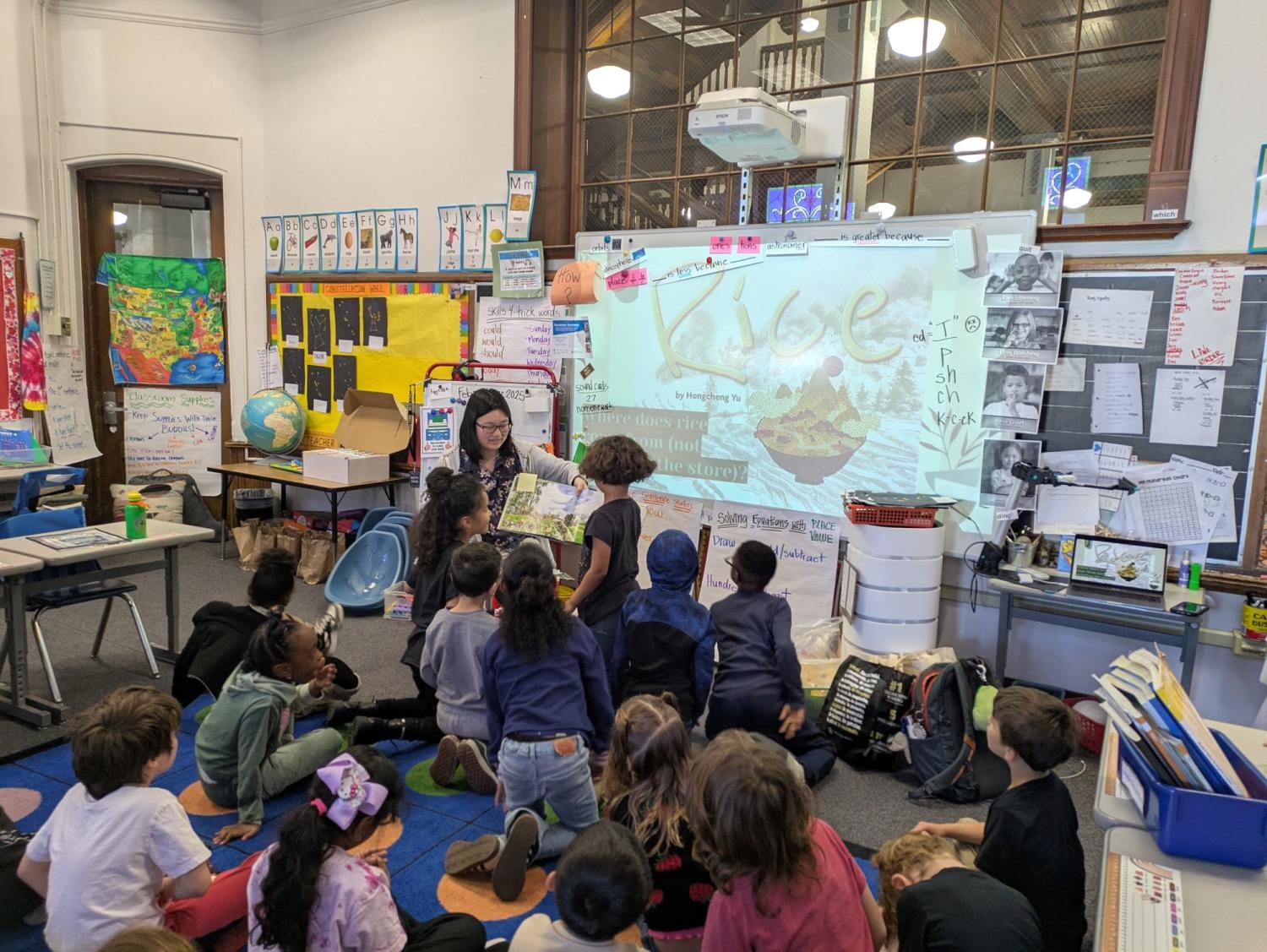 Lily Eliot reading picture book "Rice" to elementary school students