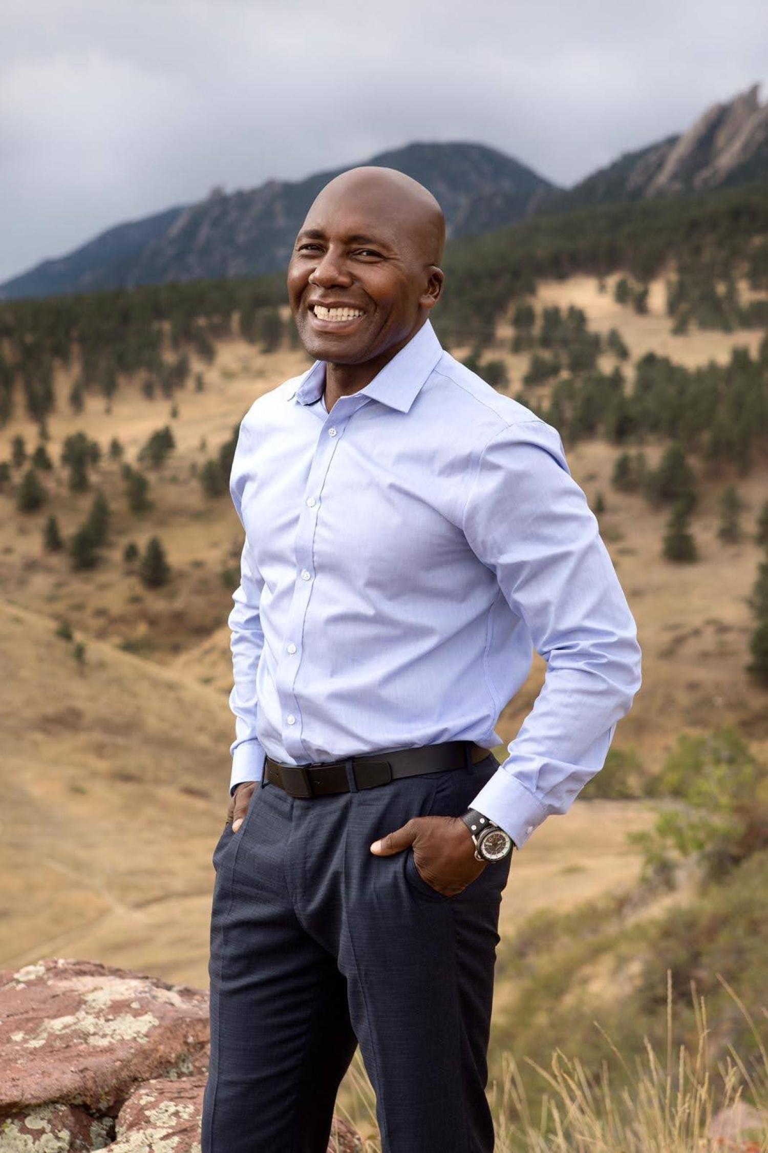 portrait of Ajume Wingo in front of Flatirons mountains