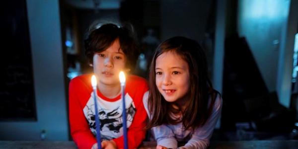 Boy and girl looking at candles