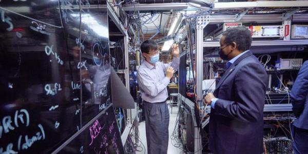 Physicist Jun Ye gives U.S. Rep. Joe Neguse a tour of his lab at JILA on the CU Boulder campus.