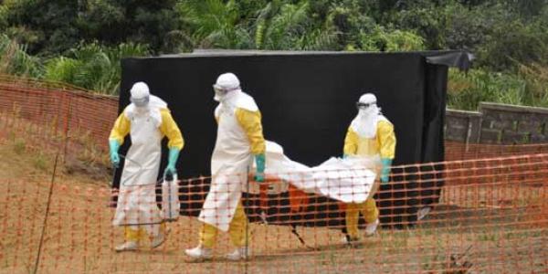 The body of a patient who passed away in Guinea is given back to the family for their funeral after being decontaminated by a team from Doctors Without Borders. Photo Amandine Colin/MSF