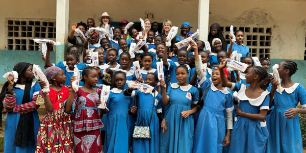 School girls holding PridePads in Cameroon