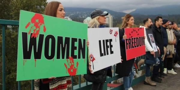 Women holding signs in Iran