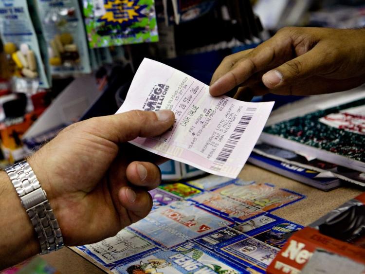 Person being handed Mega Millions ticket